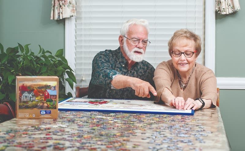 Photo: the Holms doing a jigsaw puzzle