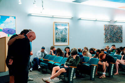 students praying over Vance Freeman at LMFA